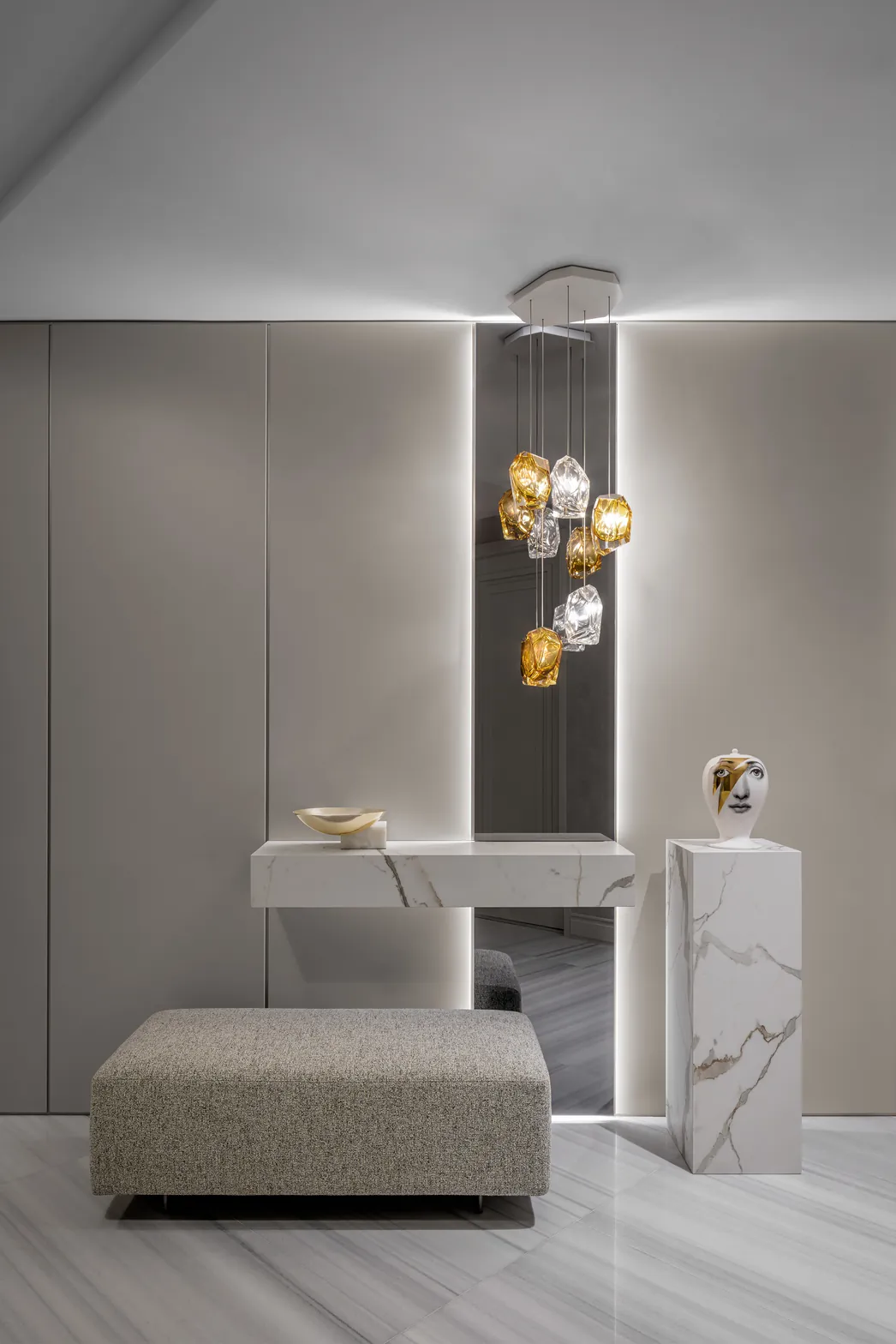 Minimal foyer with floating marble console, backlit smoked mirror and amber crystal pendant cluster, Acqualina 2303, Sunny Isles Beach