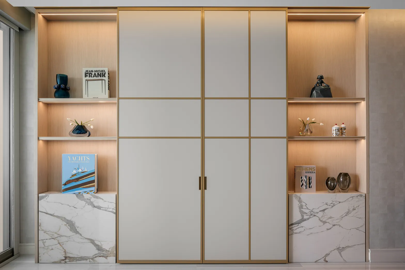 Living room millwork with brass-framed lacquer doors, lit oak shelving and marble base cabinets, Acqualina 2303, Sunny Isles Beach