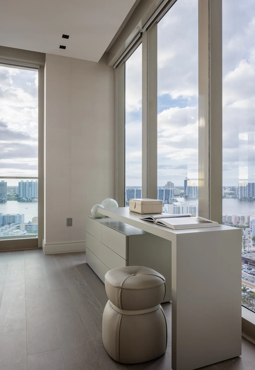 Guest bedroom desk and leather stool beside floor-to-ceiling windows with bay views, Acqualina 2303, Sunny Isles Beach