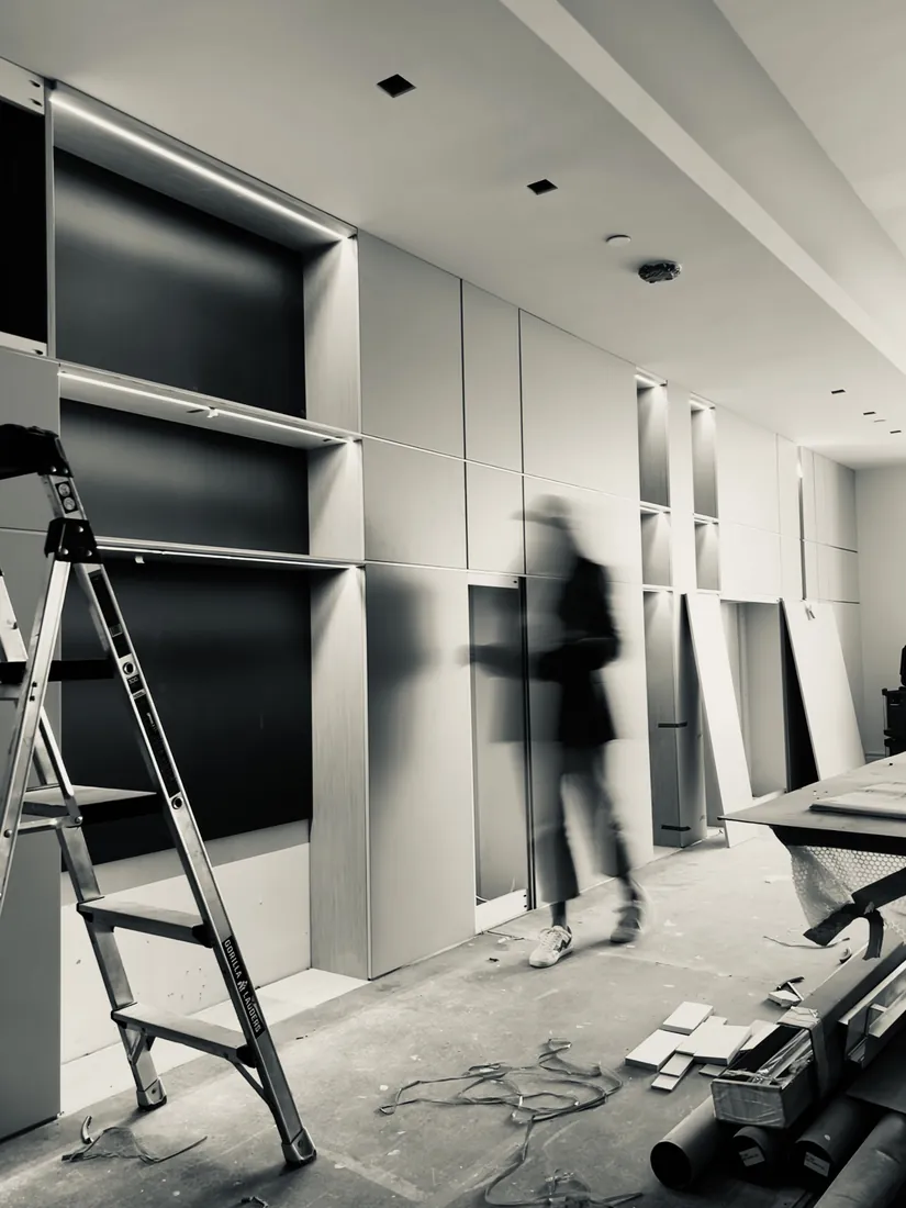 Construction process: living room millwork installation with integrated LED niches, Acqualina 2303